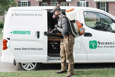 technician ready to spray for mosquitoes