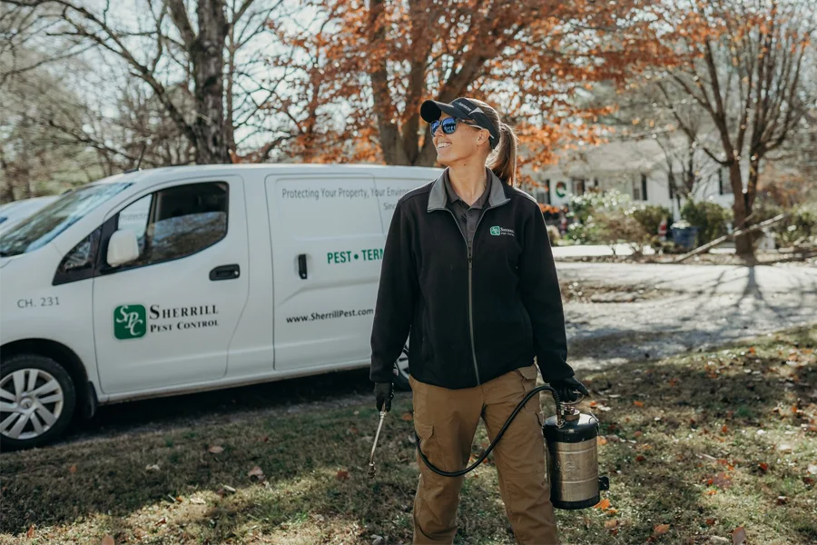 pest technician smiling and enjoying her job