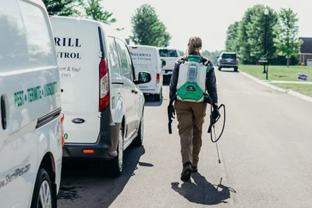 technician getting ready to spray for mosquitoes