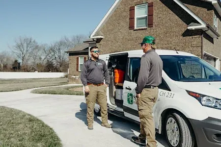 technicians standing next to Sherrill Pest Control van