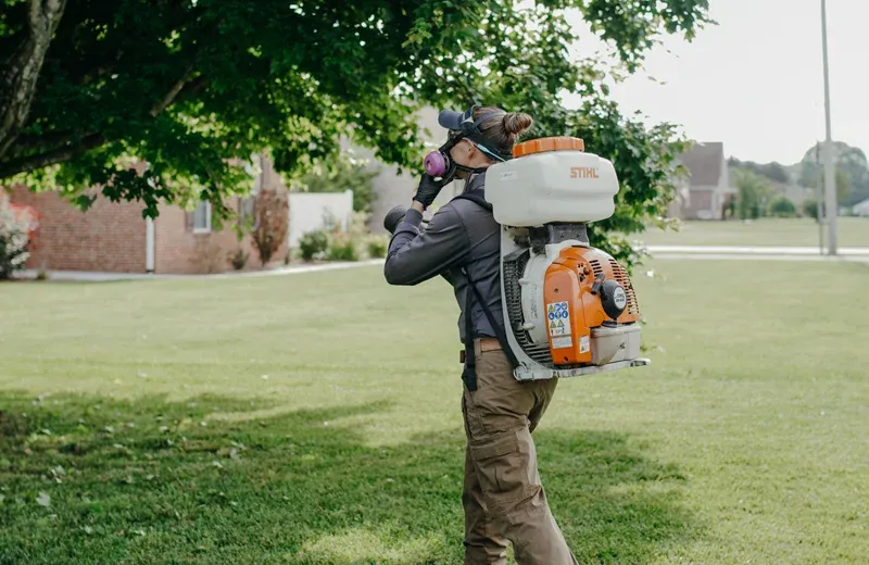 technician misting for mosquitoes